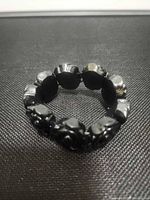 Full view of circular bracelet showing elastic structure and rose links