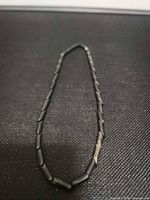 Full view of necklace laid flat showing overall length and bead type