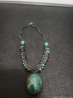 Full view of necklace showing pendant, bead strands, and slider knot