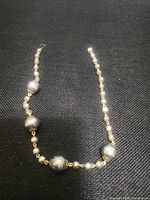 Full view of necklace displaying bead arrangement and clasp