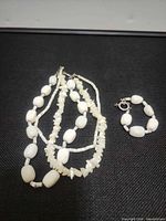 Necklace and bracelet laid out displaying whole set