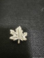 front view of silver-tone maple leaf brooch