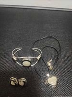 Full view of bracelet, pendant necklace and earrings