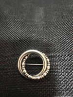 front view showing circular form and bead detailing