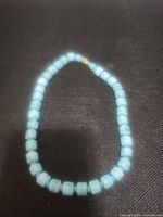 Full view of turquoise cylindrical bead necklace