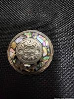 Front view showing abalone inlay and Aztec calendar motif