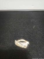 Front view of silver-tone harp brooch displaying marcasite accents