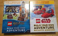 Front view of both boxed LEGO Build Your Own Adventure book sets showing titles, included minifigures and model images