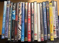Spine view of 17 assorted DVD titles