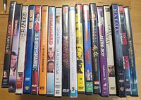 Row of approximately 18 DVD cases with visible titles