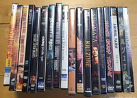 Row of approximately twenty DVD cases showing various movie titles