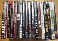 Row of approximately 18 DVD cases showing visible titles