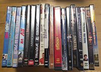 Row of approximately 18 DVD cases showing titles and spine condition.
