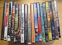 Spines of 19 DVD cases arranged side-by-side showing titles