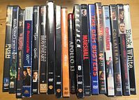 Row of 18 DVD movie cases, spines visible showing assorted titles