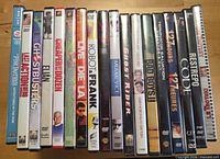 Row of eighteen DVD keep cases showing spines and titles