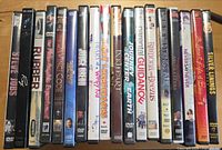Spines of 18 DVD cases showing assorted movie titles