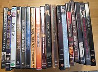 DVD spines visible showing assorted movie titles