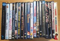 Single image showing all twenty DVD movie cases lined in a row, spines visible for title identification