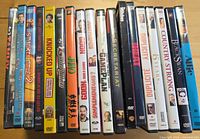 Row of nineteen DVD cases showing spines with various movie titles