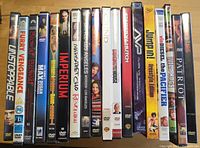 Front view of 18 DVD cases standing upright showing spines