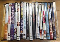 Row of 18 DVD cases standing upright showing spines