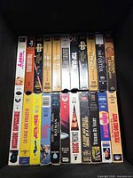 Tray of 20 VHS tapes including Mission: Impossible, La Cage Aux Folles II, Jungle Book and Top Gun visible