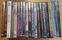 All spines visible showing sealed DVDs
