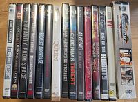Front view of all 17 factory-sealed DVD spines on tabletop