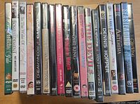 Row of 18 factory-sealed DVD cases showing titles