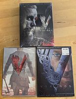 Three sealed Vikings DVD sets seasons 1-3 on tabletop