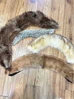 Four fur collars laid out on floor