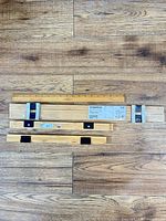 Two 61 cm poster hanger sets and one longer set shown with yardstick for scale