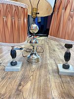 Front view showing two matching small lamps and one silver lamp