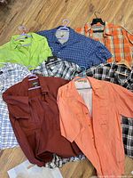 Group shot of all eight shirts laid out to show colors and patterns