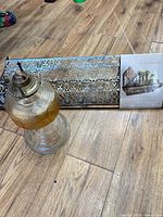 Shelf and oil lamp full view on floor