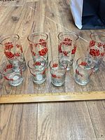 All eight glasses lined up beside ruler showing sizes