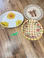 Front of three serving plates displaying designs and shapes