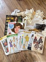 Overall lot showing magazines, pattern envelopes and lace box on floor