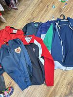 Group of six lightweight spring jackets on hangers