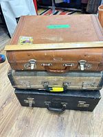 Stacked view of three vintage suitcases