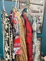 Seven patterned shirts hanging on rack