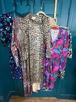 All six dresses hanging showing variety of prints