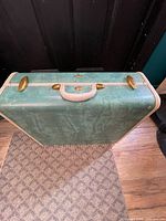 Front view showing green exterior, cream trim, brass hardware, handle