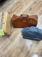 Group shot of all three suitcases on wood floor