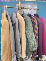 Rack displaying eight assorted jackets and blazers