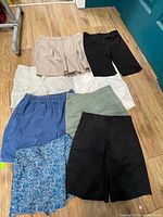 All eight pairs laid on floor showing variety of colours and styles