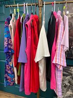 Rack with 12 assorted women’s tops in varied colours and styles