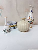 Group view of four decorative porcelain pieces