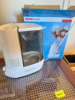 Humidifier unit beside original CVS Health box on tabletop